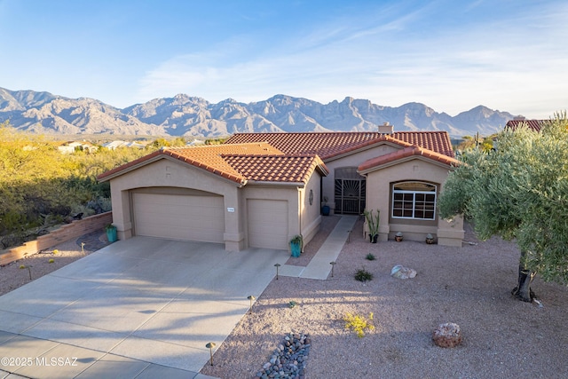 view of front of house with a garage and a mountain view