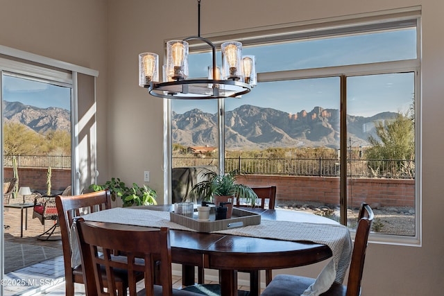 dining area featuring a mountain view and a notable chandelier