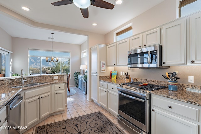 kitchen with white cabinetry, stainless steel appliances, light tile patterned flooring, and sink