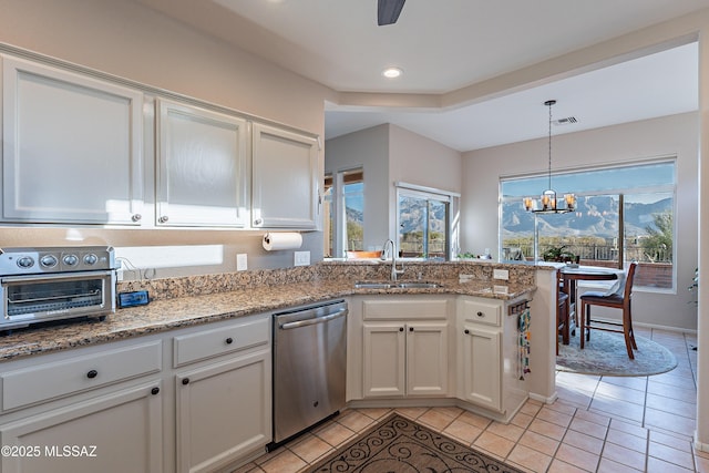 kitchen with dishwasher, sink, light tile patterned flooring, and white cabinets