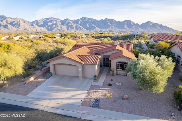 view of front of home featuring a garage and a mountain view