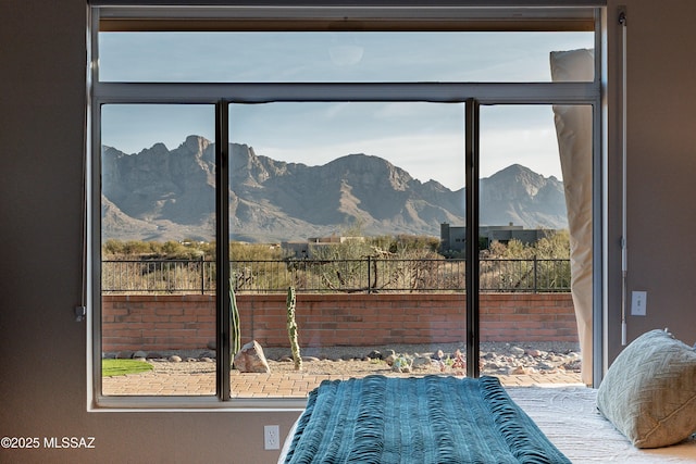 bedroom featuring multiple windows and a mountain view