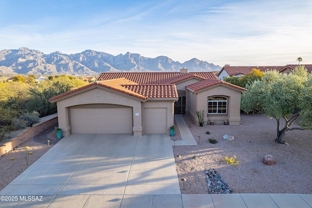 view of front facade with a garage and a mountain view