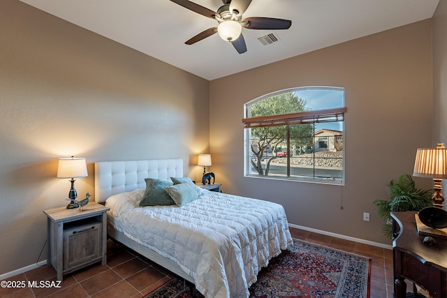 tiled bedroom featuring ceiling fan