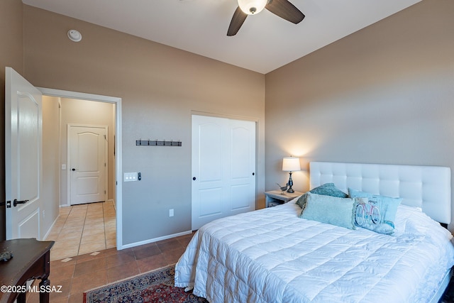 tiled bedroom featuring a closet and ceiling fan