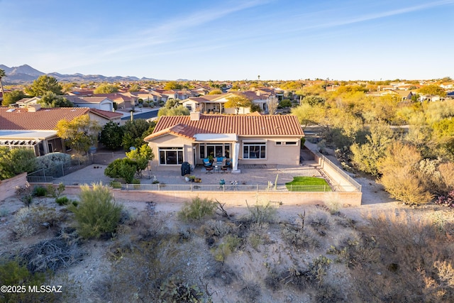 rear view of property with a patio and a mountain view