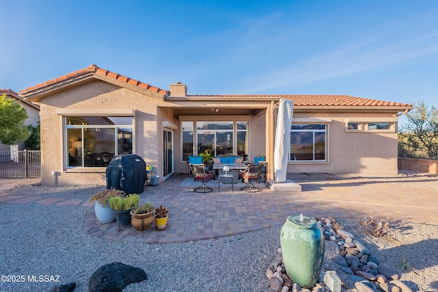 rear view of property featuring a patio area