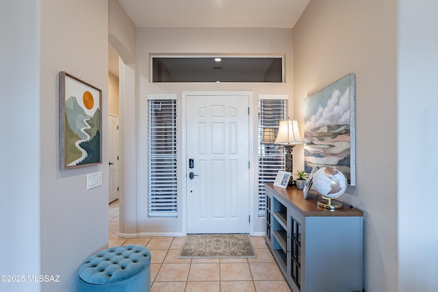 foyer entrance with light tile patterned floors