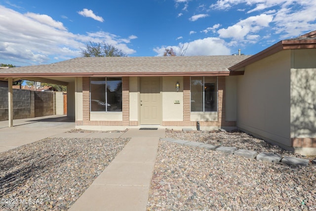 property entrance featuring a carport