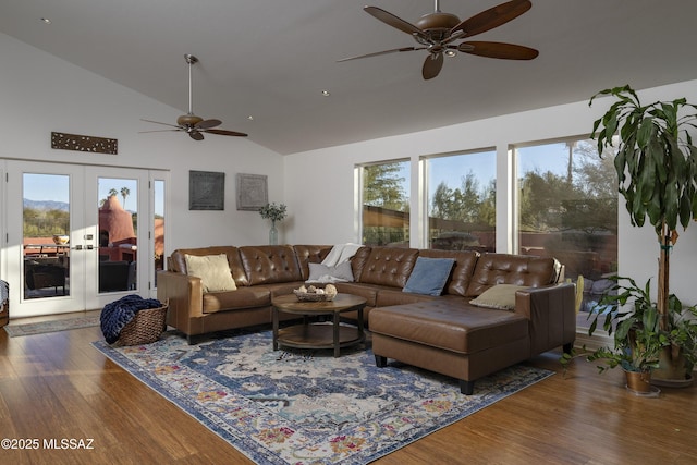 living room with hardwood / wood-style flooring, high vaulted ceiling, french doors, and ceiling fan