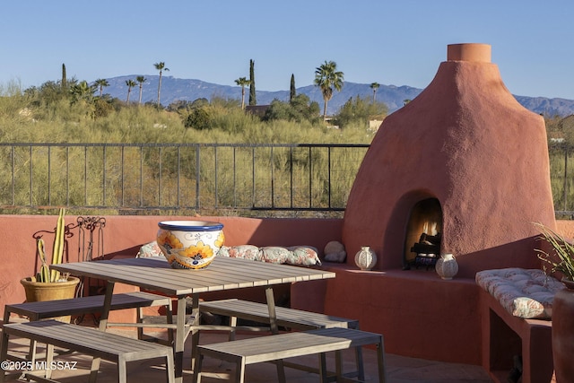 exterior space with a mountain view and a fireplace