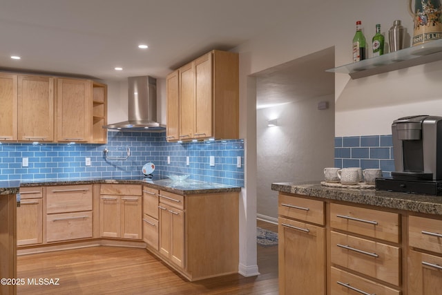 kitchen featuring light hardwood / wood-style flooring, wall chimney exhaust hood, and light brown cabinets