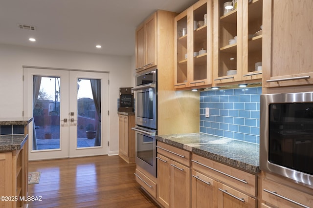 kitchen featuring tasteful backsplash, dark hardwood / wood-style flooring, french doors, stainless steel double oven, and light brown cabinets