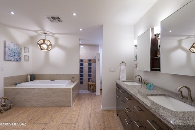 bathroom with wood-type flooring, separate shower and tub, and vanity