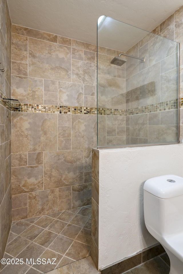 bathroom with tiled shower