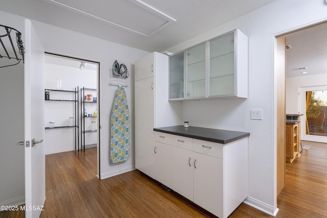 kitchen with white cabinetry and dark wood-type flooring