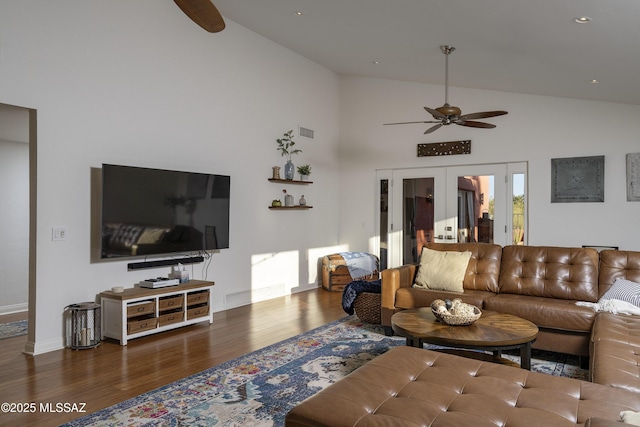 living room featuring dark wood-type flooring, high vaulted ceiling, french doors, and ceiling fan