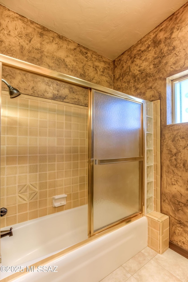 bathroom featuring enclosed tub / shower combo and tile patterned flooring