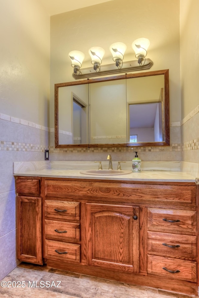 bathroom featuring tile walls and vanity