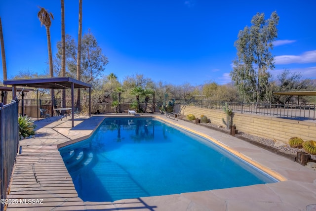 view of swimming pool featuring a diving board and a gazebo