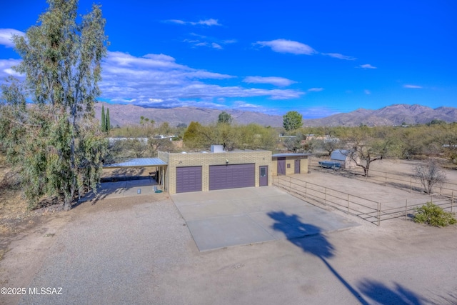 exterior space with a garage and a mountain view