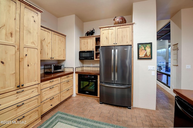 kitchen with light brown cabinets and black appliances