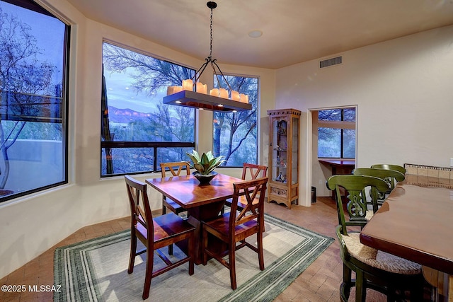 dining room with a mountain view and a chandelier