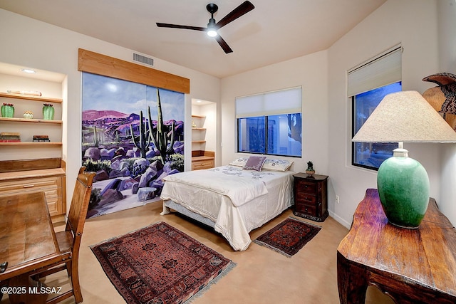 bedroom with ceiling fan, light carpet, and ensuite bath