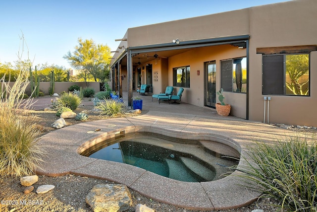 view of swimming pool featuring a patio, ceiling fan, and a jacuzzi