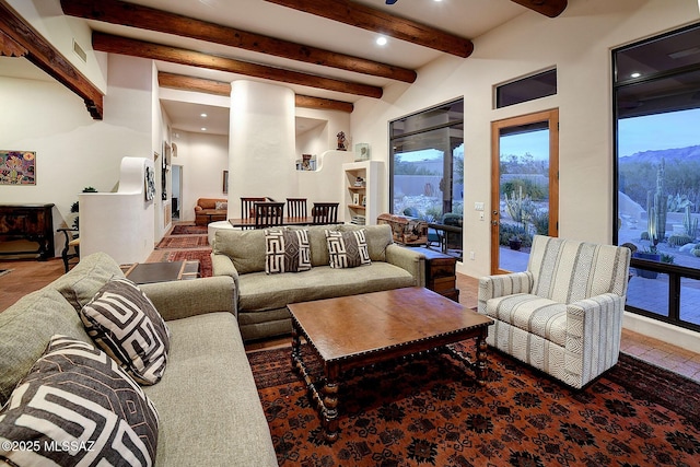 living room featuring beamed ceiling and a mountain view