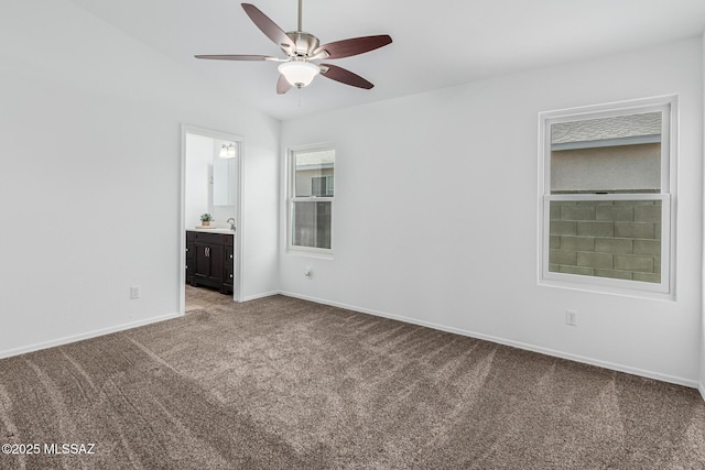 spare room featuring ceiling fan, carpet floors, and sink