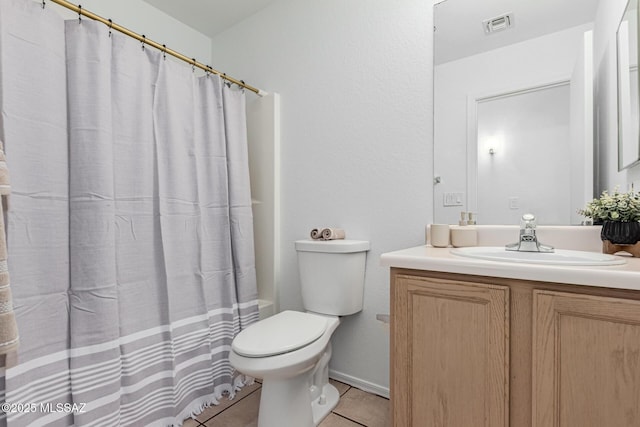 bathroom featuring toilet, tile patterned floors, and vanity