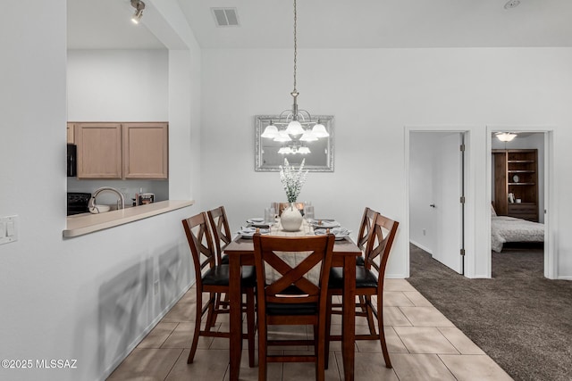 dining room featuring carpet floors and a notable chandelier