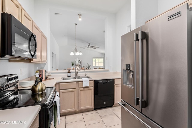 kitchen featuring decorative light fixtures, vaulted ceiling, black appliances, sink, and ceiling fan with notable chandelier