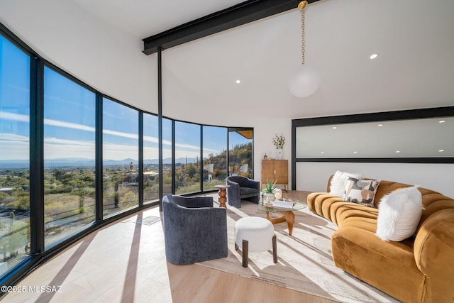 living room featuring lofted ceiling with beams and light wood-type flooring