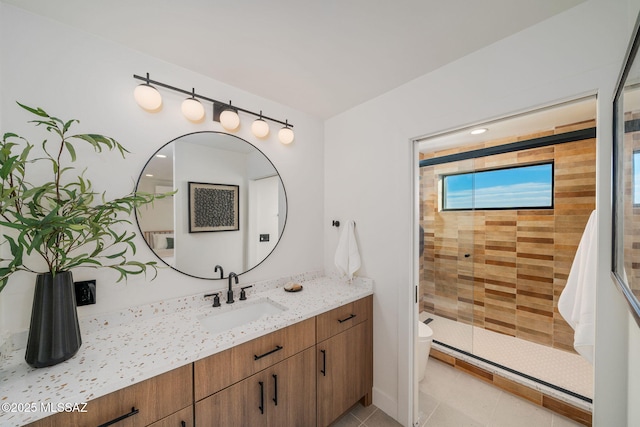 bathroom with vanity, tile patterned flooring, a shower with shower door, and toilet