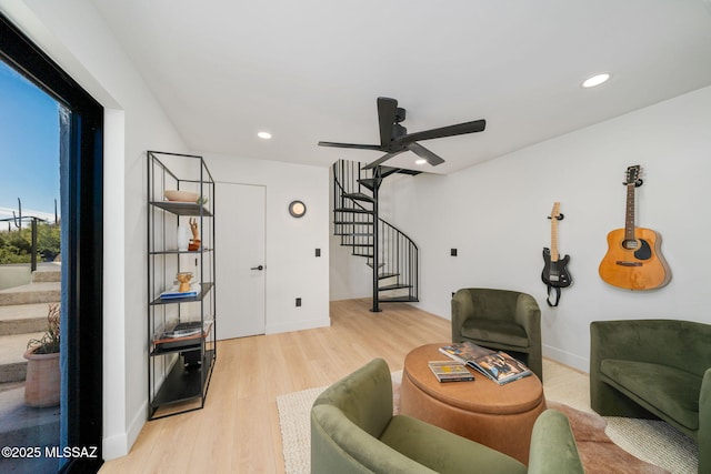 living room with light hardwood / wood-style floors and ceiling fan