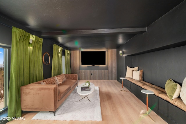 cinema with light hardwood / wood-style flooring and wood walls