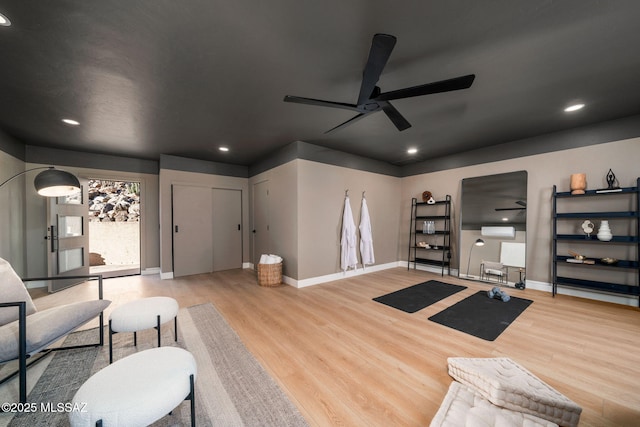 living room with ceiling fan and light hardwood / wood-style flooring