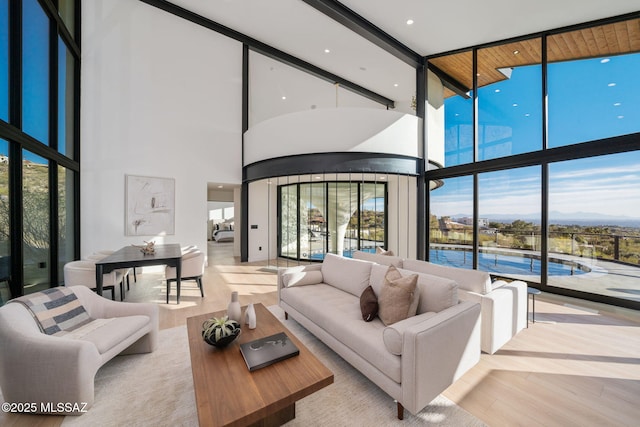 living room with floor to ceiling windows and light hardwood / wood-style floors