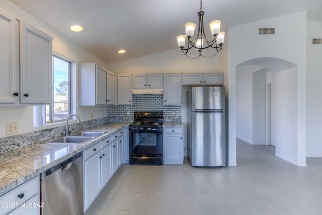 kitchen featuring pendant lighting, vaulted ceiling, sink, backsplash, and stainless steel appliances