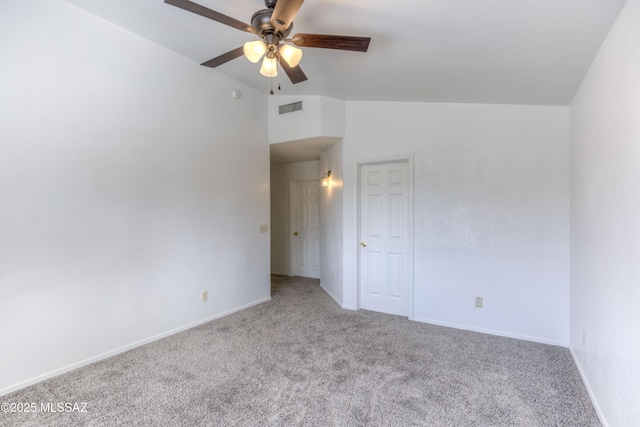 carpeted spare room featuring ceiling fan and lofted ceiling