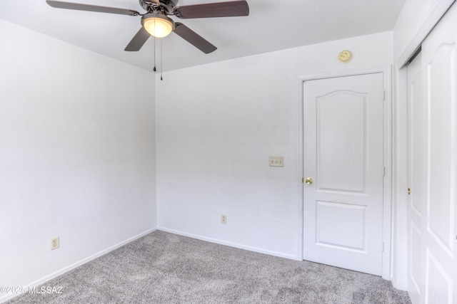 empty room featuring light colored carpet and ceiling fan