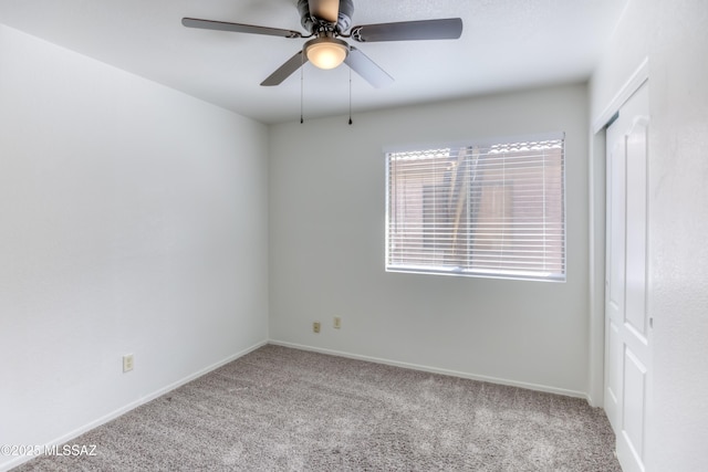 unfurnished room featuring light carpet and ceiling fan