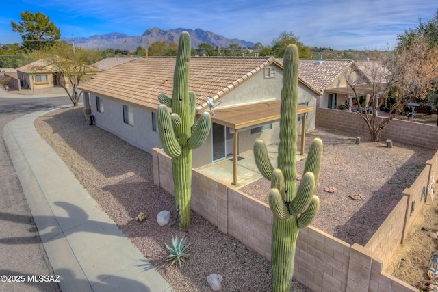 view of property exterior featuring a mountain view and a patio