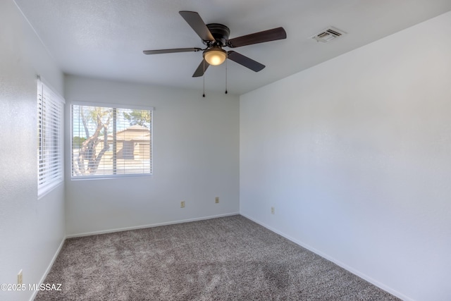 carpeted spare room featuring ceiling fan