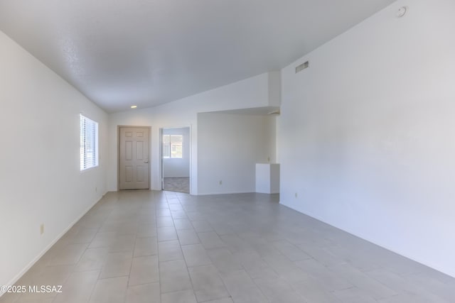 spare room featuring lofted ceiling