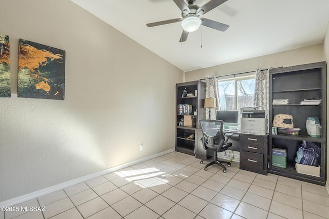 office area with a ceiling fan, lofted ceiling, light tile patterned flooring, and baseboards