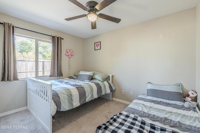 bedroom with light carpet, ceiling fan, and baseboards