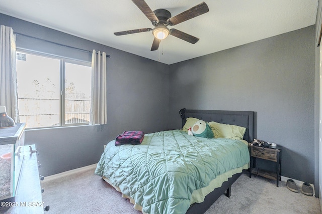 bedroom with baseboards, ceiling fan, and light colored carpet